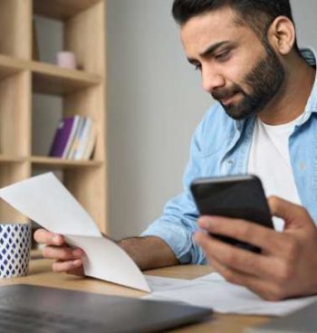 young-indian-business-man-holding-phone-reading-ba-2021-09-02-20-11-45-utc (3)